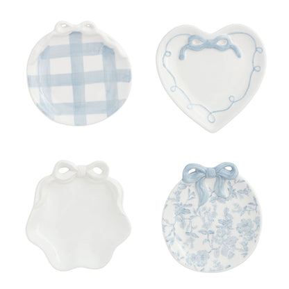 4 assorted blue and white small dishes on a white background