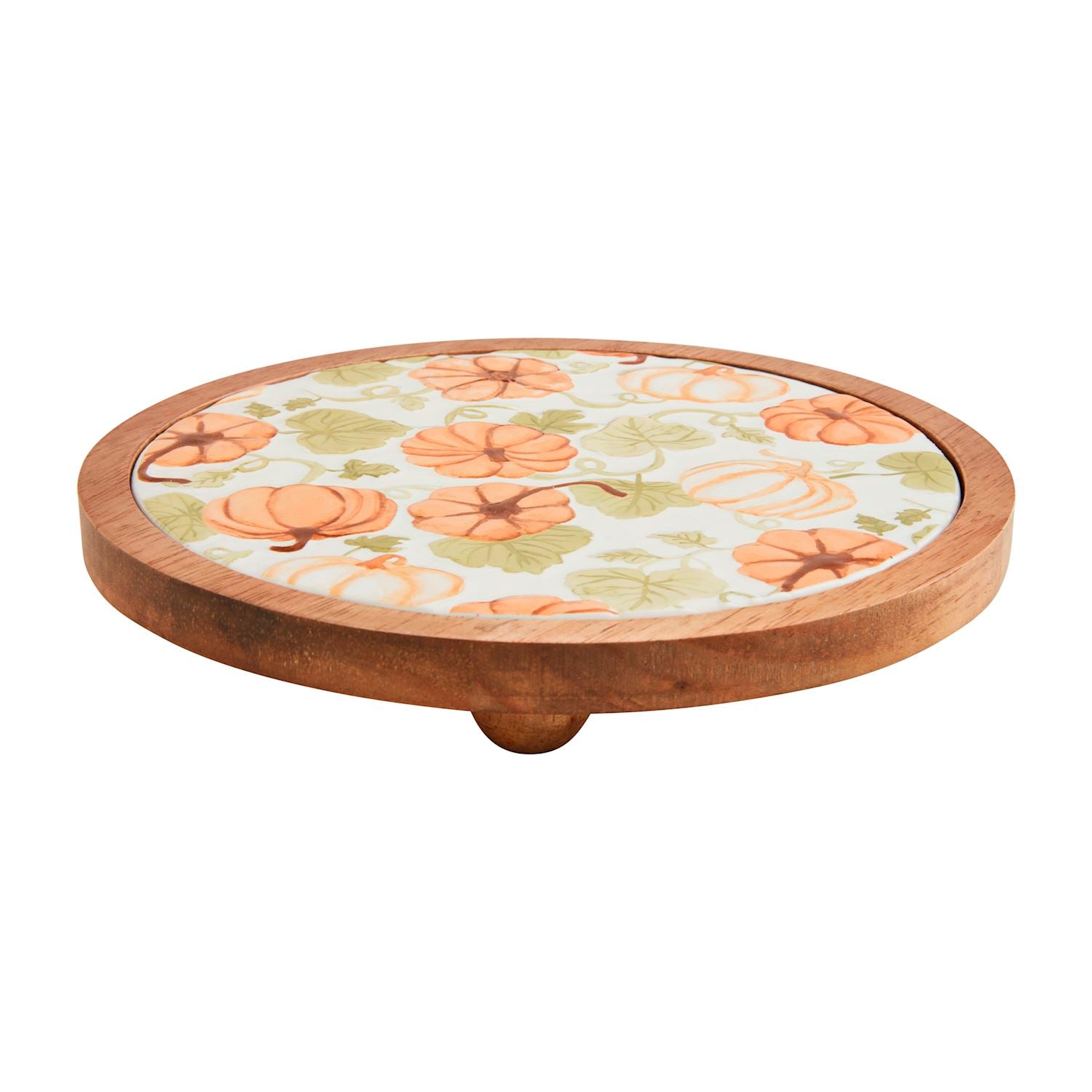 wooden trivet with ceramic inlay painted with pumpkins and leaves.