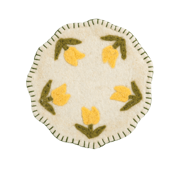 white Felted Floral Trivet with design of yellow flowers in a circle and green stitched trim