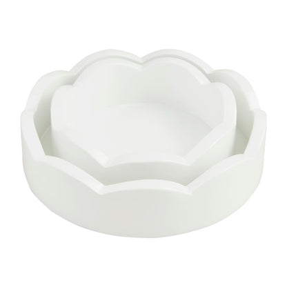 Two sizes of round white scalloped edge trays nested together.