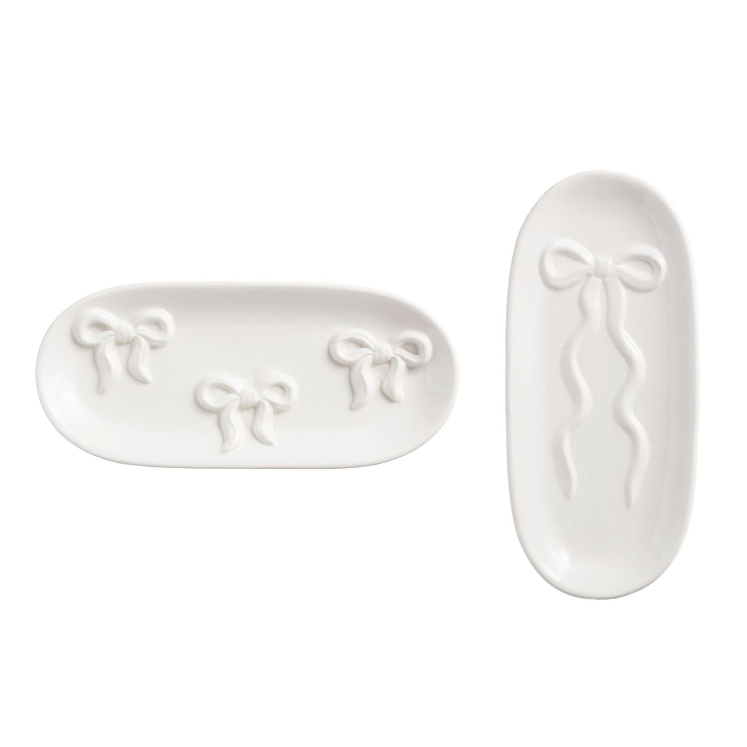 Two white ceramic trays with bow designs on a white background