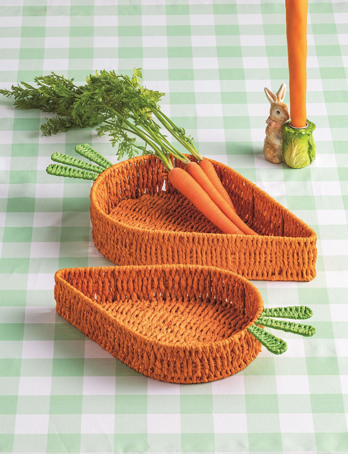 woven carrot trays set on a green gingham cloth with carrots in the larger tray