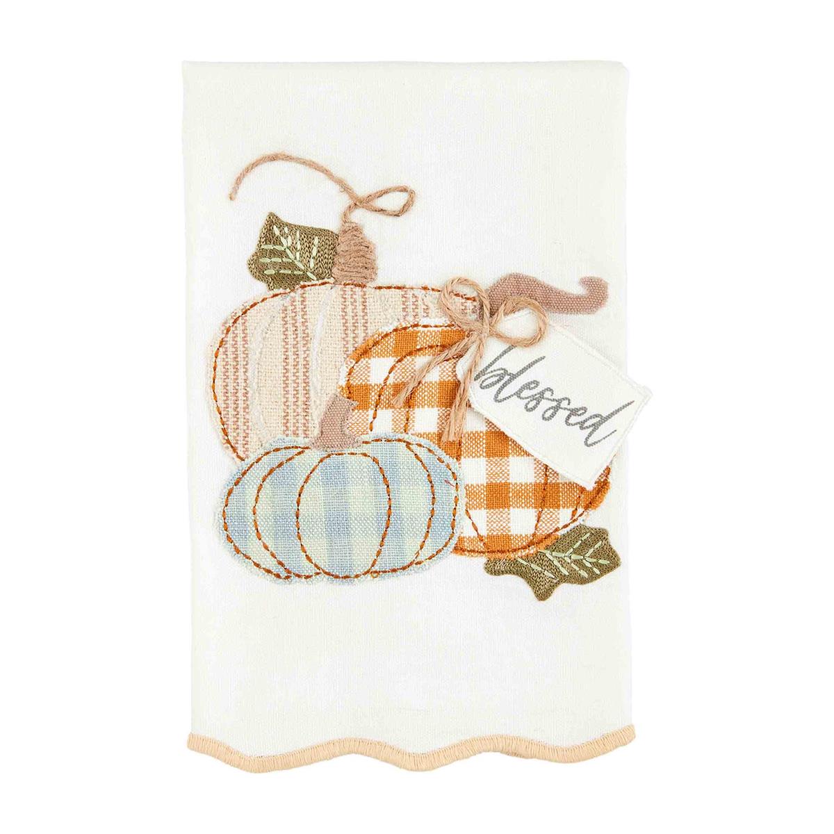 white towel with 3 pumpkins and a tag with "blessed" embroidered on it.