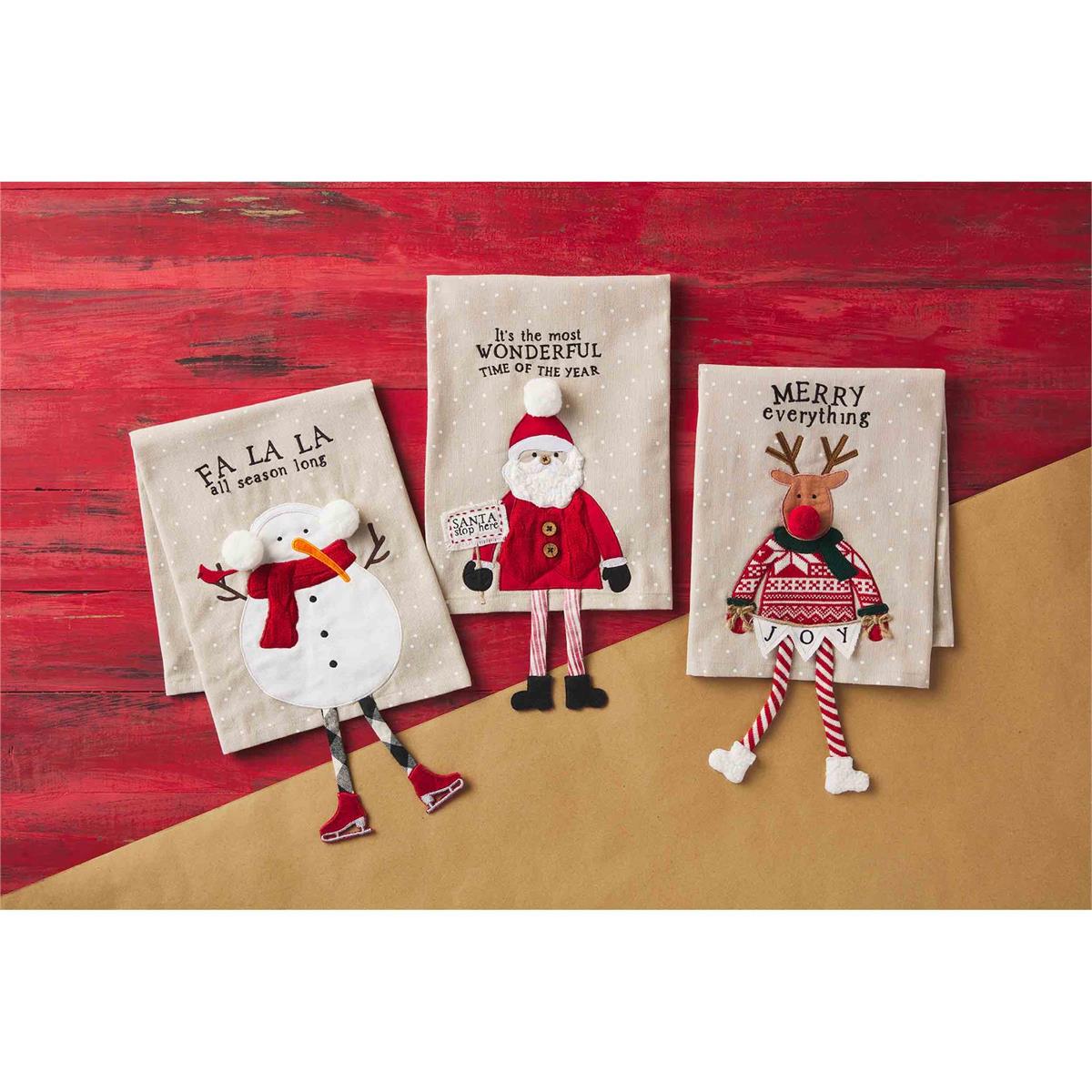 all three styles of christmas dangle leg towels displayed on a red table with brown butcher paper