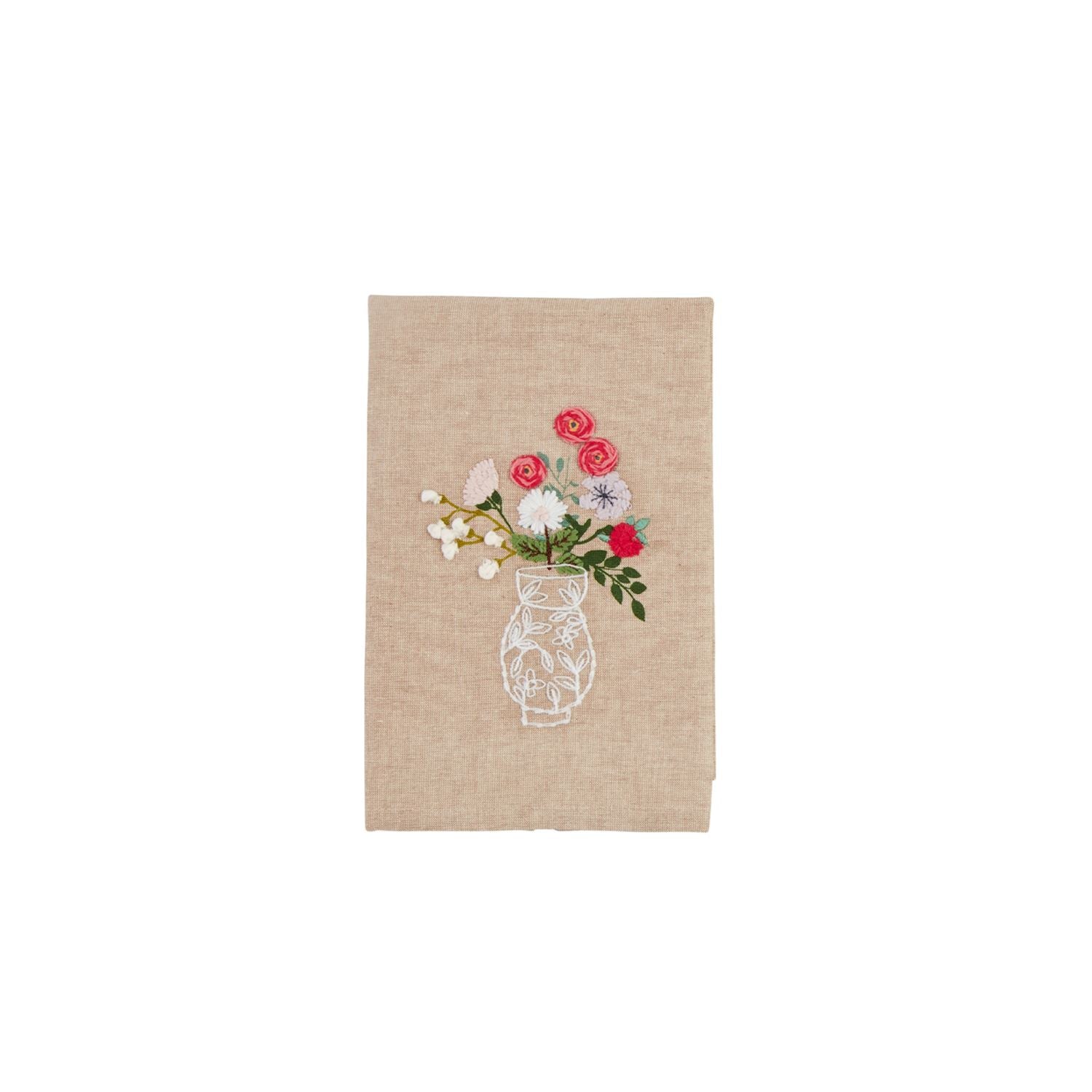 Beige towel with embroidered design of a vase with flowers shown on a white background