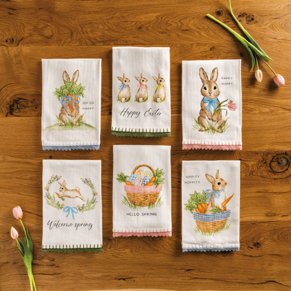 Easter-themed towels arranged on a wooden surface with tulips.