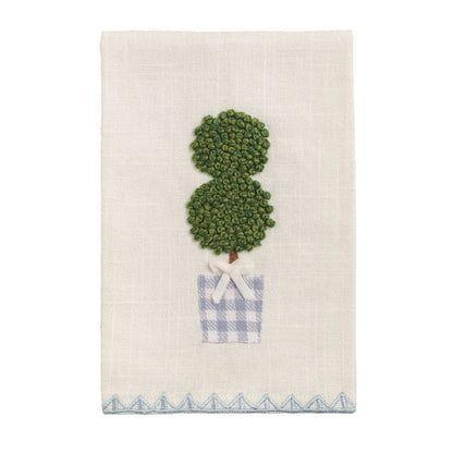 Decorative tea towel with a green topiary design and blue checkered pot on a white background