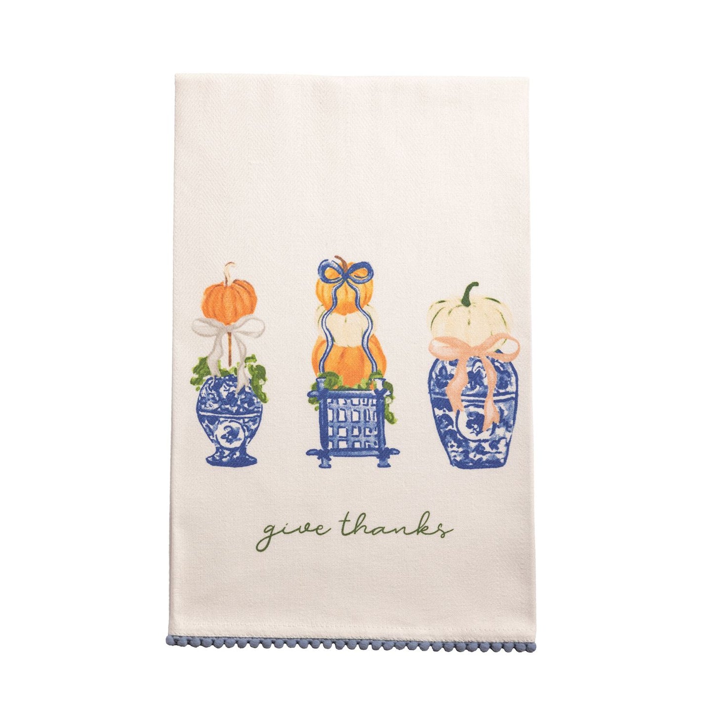 Give Thanks Topiary Towel with a design of 3 pumpkin topiaries in blue and white and "give thanks" printed in script across the bottom above and mini pom hem