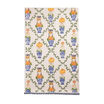 Pattern Topiary Towel with design of a vining lattice and pumpkin topiaries in blue and orange and a mini pom hem