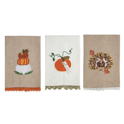 3 fall themed dishtowels in a row on a white background