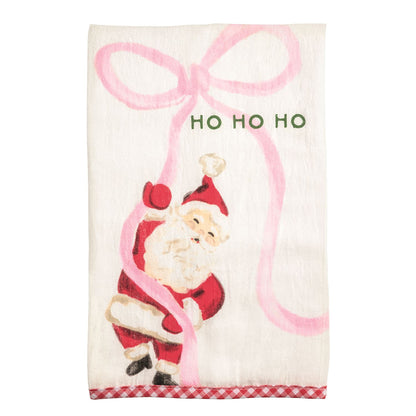 Whimsy Christmas Towel printed with playful image of santa holding a large pink bow and 'ho ho ho' at the top