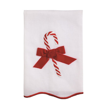 White towel with a red bow and candy cane design on a white background