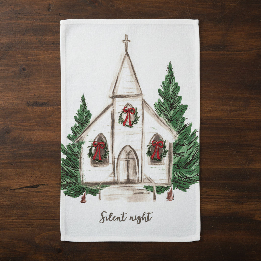 white towel painted with the image of a country church with holiday wreaths hanging on the windows and evergreen trees on each side
