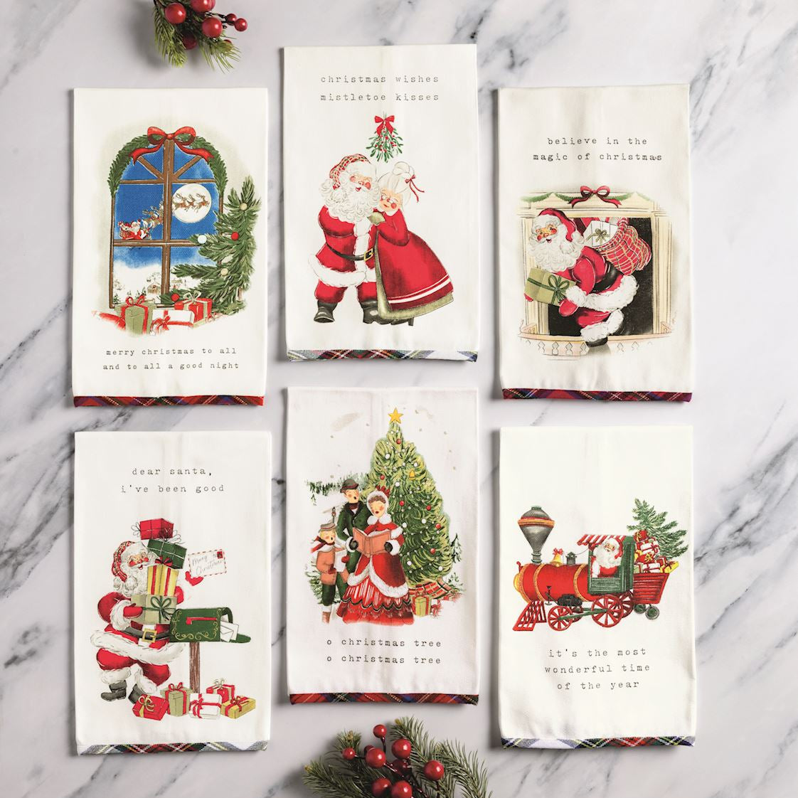 6 assorted holiday scene towels on a marble surface