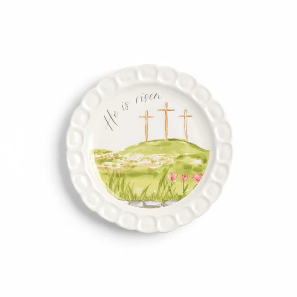 round white plate with hilly scene, 3 crosses, and he is risen printed on it
