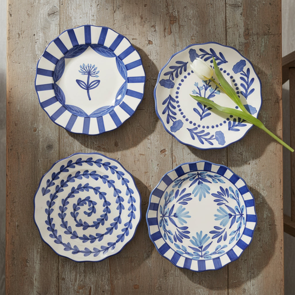 4 blue and white salad plates with floral designs arranged on a wooden table