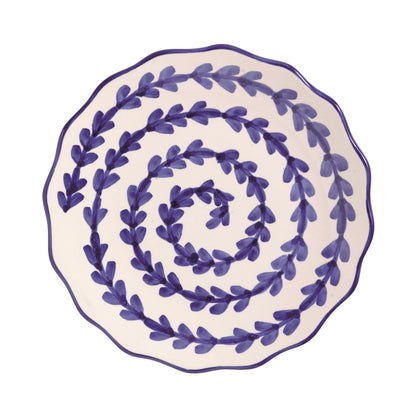 Decorative plate with blue leaf vining pattern on a white background