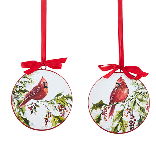 2 round disc ornaments painted with a cardinal perched on a holly branch and hanging from red ribbons.