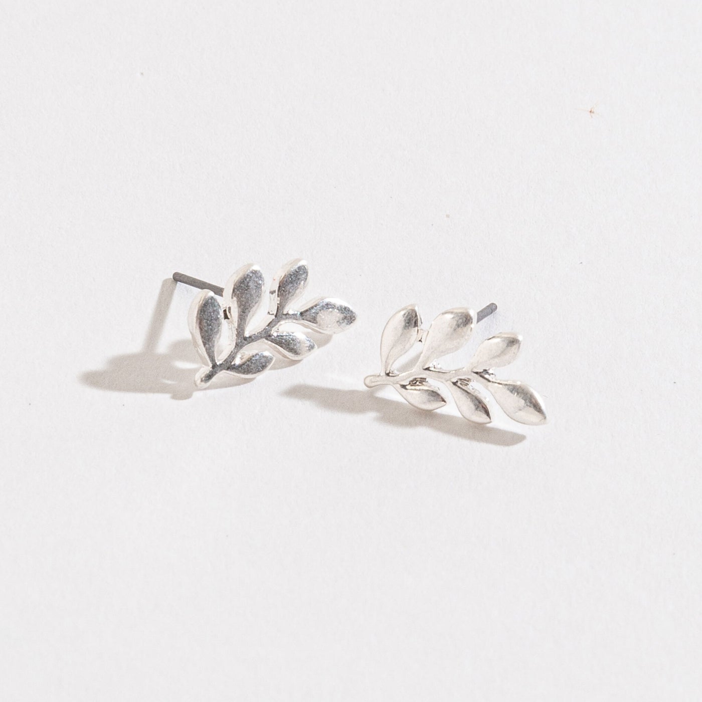 silver leaf stud earrings on a white background