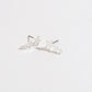 silver shotting star stud earrings on a white background