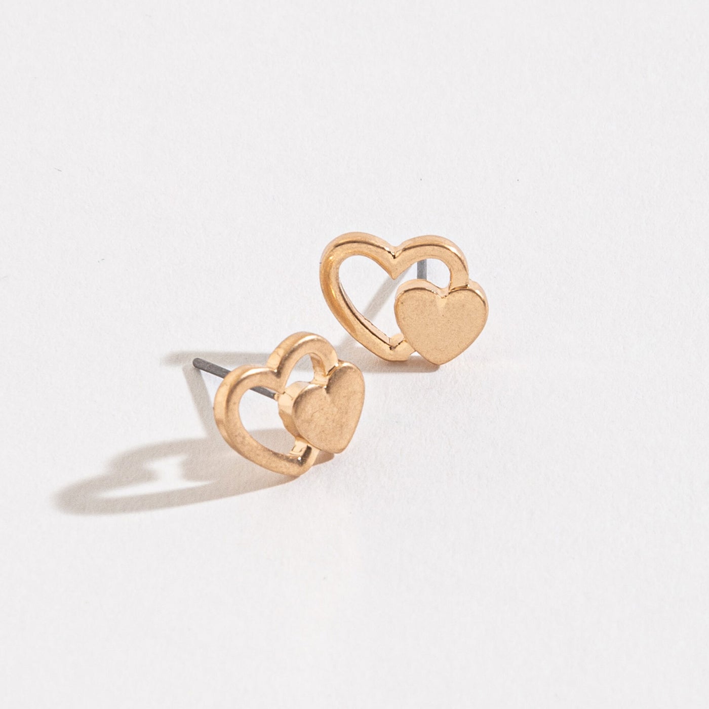 gold double heart stud earrings on a white background