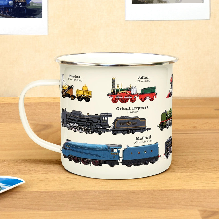 cream colored enameled mug with various types of trains on it on a wood table