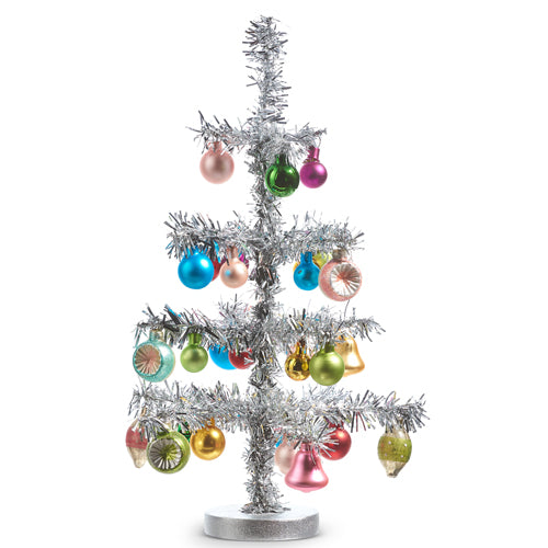 silver tinsel tree with pastel ornaments on it.