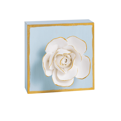 blue wooden block edged in gold with white rose on it, petals are trimmed in gold
