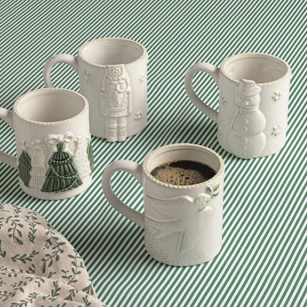 4 mugs on a green and white striped table