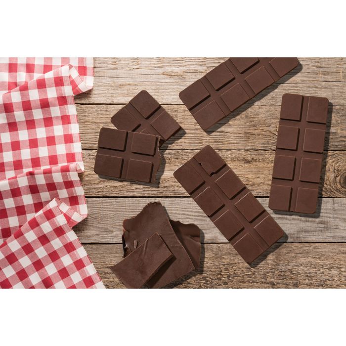 Chocolate bars on a wooden surface with a red and white checkered cloth.