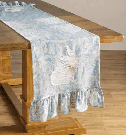 Blue Toile Easter Table Runner draped over the end of a wooden table