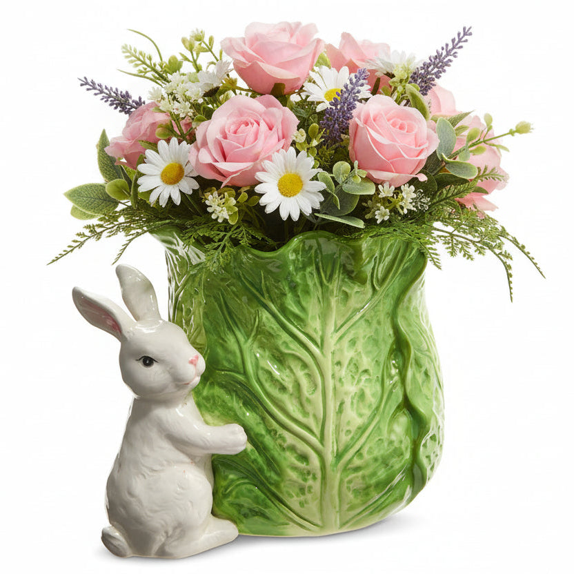 ceramic bunny next to a cabbage shaped vase filled with pink and white florals