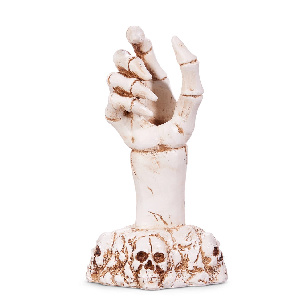 Artificial skeleton hand designed to hold a taper candle