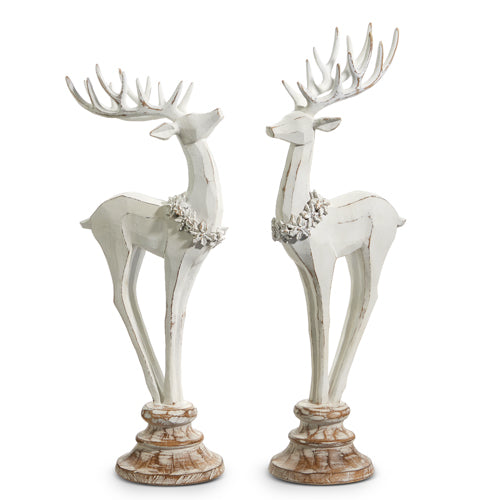 2 white deer figurines on pedestals.