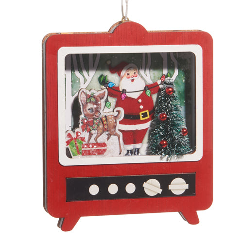 red tv ornament with santa, a tree, and reinderr inside.