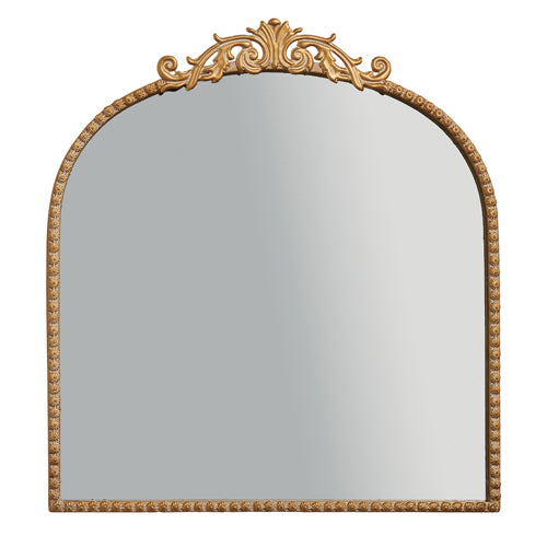 An antiqued gold mirror with a decorative iron frame.