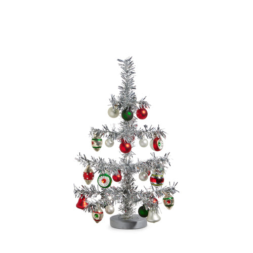 silver tinsel tree with colorful ornaments on it.