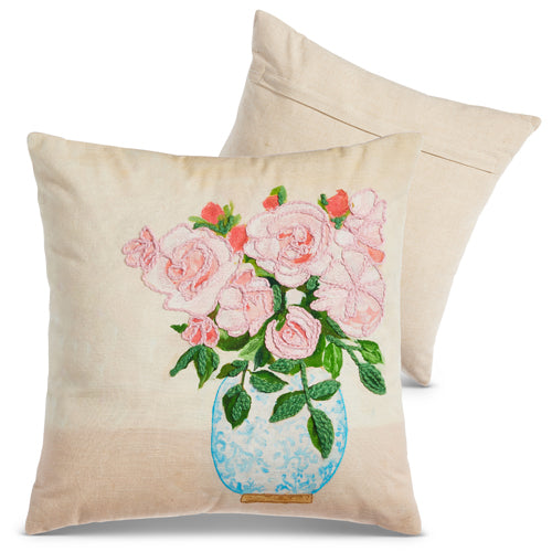 front of pillow with pink flowers in blue vase design and a the reverse side of the pillow behind it.