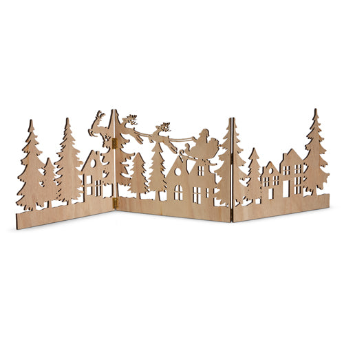 wooden silhouette scene of houses, trees, and santa flying above arranged on a white background.