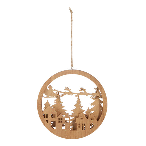 round wooden ornament with houses, trees, and santa in his sleigh in the center.