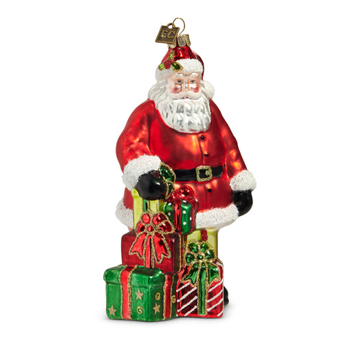 glass santa ornament with colorful wrapped gifts at his feet.