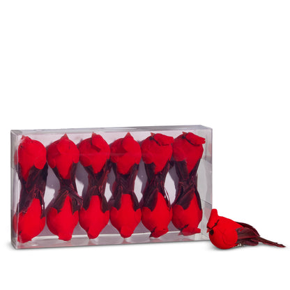 Red cardinal figurines in a clear box on a white background