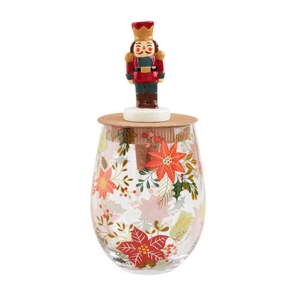 poinsettia wine glass and nutcracker stopper set displayed against a white background
