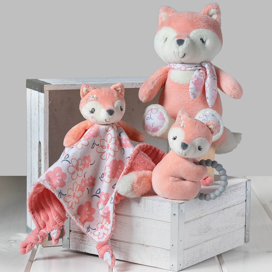 Fox Character Blanket displayed next to plush fox, fox rattle teether, and displayed on whitewashed wood box