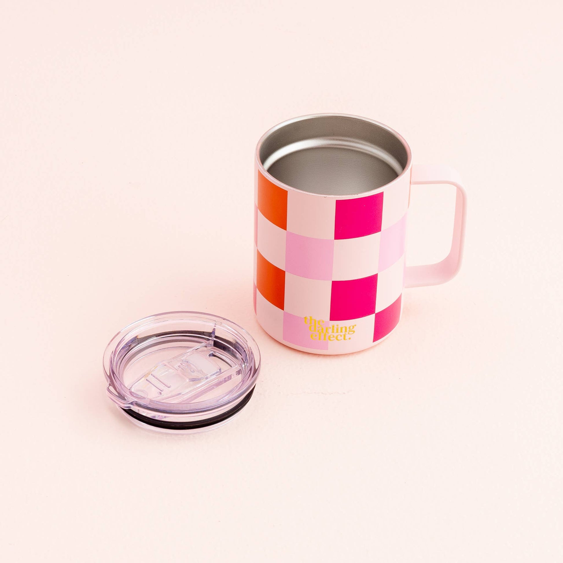 sweetheart check insolated mug with its lid set next to it on a white background.