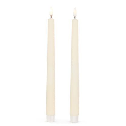 11 inch ivory taper candles with flame on.