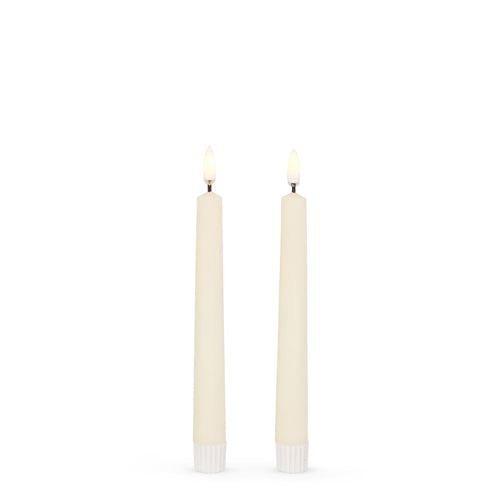 7 inch ivory taper candles with flame on.