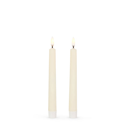 7 inch ivory taper candles with flame on.