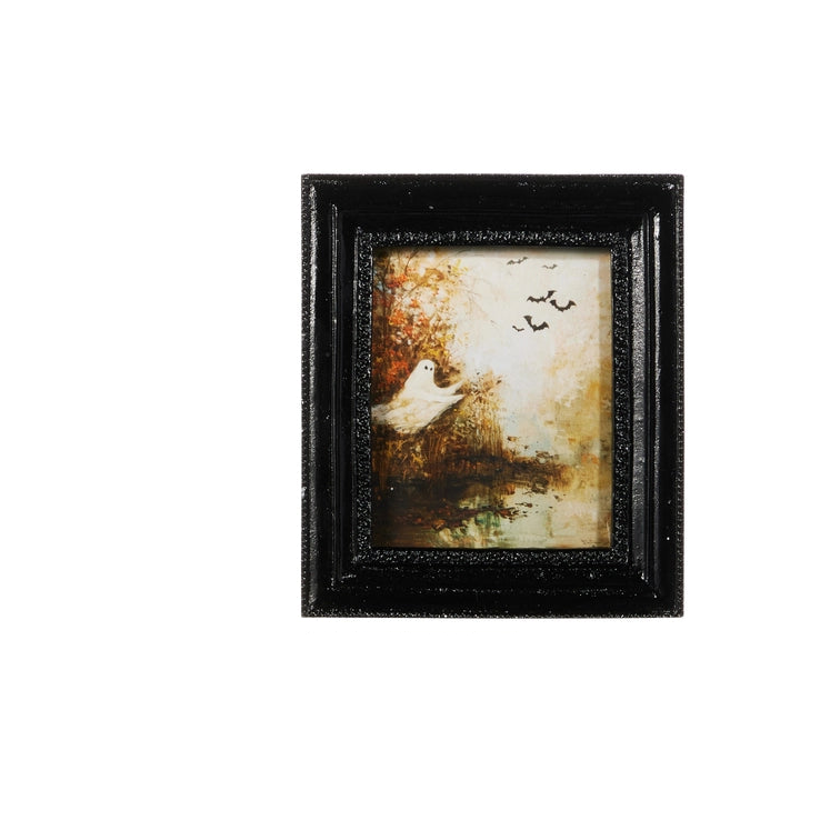 A small framed art print featuring a white ghost standing among autumn trees with birds in the sky, enclosed in a textured black frame against a white background.