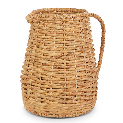 A woven natural pitcher vase made of water hyacinth with a handle and small spout.